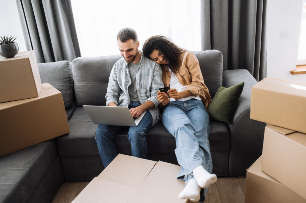 Couple strategizing their long-distance move on a couch