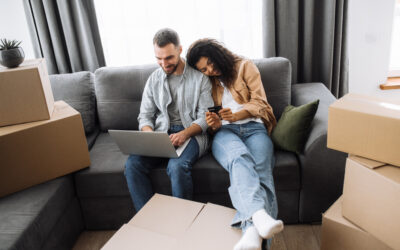 Couple strategizing their long-distance move on a couch