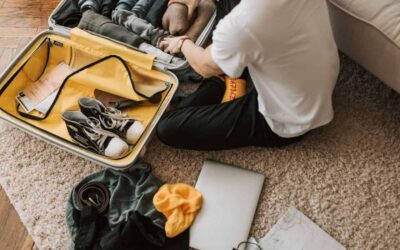 Man packing luggage on the floor