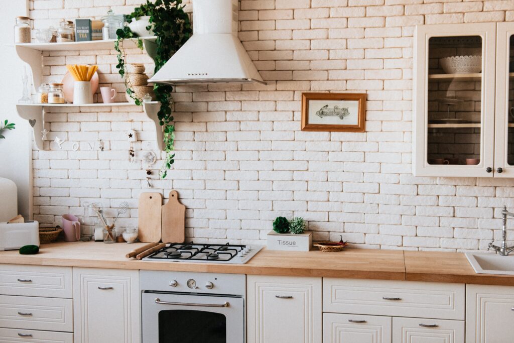 A quaint kitchen with a brick wall